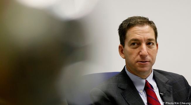 Glenn Greenwald, a reporter of The Guardian, speaks during an interview in Hong Kong Monday, June 10, 2013. Greenwald reported a 29-year-old contractor who claims to have worked at the National Security Agency and the CIA allowed himself to be revealed Sunday as the source of disclosures about the U.S. government's secret surveillance programs, risking prosecution by the U.S. government.  (AP Photo/Kin Cheung)